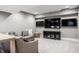 Cozy basement living area featuring a comfortable sectional and mounted TVs for entertainment at 496 Bridgemont Ln, Carmel, IN 46032