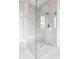 Modern bathroom with frameless shower featuring a shower seat and herringbone tile at 496 Bridgemont Ln, Carmel, IN 46032
