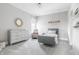 Bright bedroom featuring modern gray furnishings, natural light, and calming decor elements at 496 Bridgemont Ln, Carmel, IN 46032