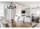 Open concept dining room featuring a stone fireplace and easy access to kitchen and living room at 496 Bridgemont Ln, Carmel, IN 46032