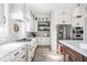 Bright kitchen with white cabinets, stainless steel appliances, and gas cooktop at 496 Bridgemont Ln, Carmel, IN 46032