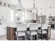 Bright kitchen features white cabinetry, stainless appliances, and a center island with counter seating at 496 Bridgemont Ln, Carmel, IN 46032
