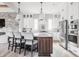 Gourmet kitchen featuring white cabinets, quartz countertops, and stainless steel appliances at 496 Bridgemont Ln, Carmel, IN 46032