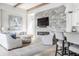 Cozy living room featuring a stone fireplace, comfortable seating, and an open layout at 496 Bridgemont Ln, Carmel, IN 46032