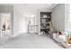 Spacious loft area featuring stylish decor, built-in shelving, plush seating, and ample natural light at 496 Bridgemont Ln, Carmel, IN 46032