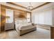 Cozy main bedroom featuring a wood accent wall, recessed lights, and a decorative ceiling at 496 Bridgemont Ln, Carmel, IN 46032