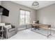 Bright and spacious office with modern light fixture, large window, and comfortable armchair at 496 Bridgemont Ln, Carmel, IN 46032