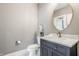 Charming powder room featuring a vanity with marble countertop, modern fixtures, and decorative accents at 496 Bridgemont Ln, Carmel, IN 46032