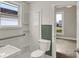 Bathroom featuring a white toilet, shower and fixtures and a window for natural light at 508 Miller Ave, Shelbyville, IN 46176
