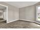 Neutral colored bedroom with carpet, white trim and a window to the outside at 508 Miller Ave, Shelbyville, IN 46176