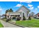 Charming two-story home with a manicured lawn and a covered front porch on a sunny day at 508 Miller Ave, Shelbyville, IN 46176