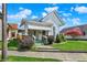 Inviting two-story home featuring a covered front porch and beautifully landscaped front yard at 508 Miller Ave, Shelbyville, IN 46176