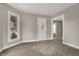 A bright living room with a large window, neutral walls, and doorway to another room at 508 Miller Ave, Shelbyville, IN 46176
