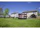 Large backyard featuring a deck, hot tub, trampoline and well-maintained lawn, perfect for outdoor activities at 5236 Skipping Stone Dr, Indianapolis, IN 46237