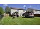 Large, fenced backyard showcasing a deck with a grill and a trampoline, perfect for Gathering fun at 5236 Skipping Stone Dr, Indianapolis, IN 46237