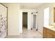 Open bathroom featuring tiled floors, a vanity with drawers, large mirror, and a tub/shower combo at 5236 Skipping Stone Dr, Indianapolis, IN 46237