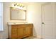 Bathroom with dual sinks, cabinets, large mirror, and overhead lighting at 5236 Skipping Stone Dr, Indianapolis, IN 46237