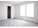 Bedroom featuring neutral gray carpet flooring, cord on the floor, and window with blinds at 5236 Skipping Stone Dr, Indianapolis, IN 46237