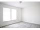Bedroom featuring neutral gray carpet flooring, window with blinds, and a ceiling light at 5236 Skipping Stone Dr, Indianapolis, IN 46237