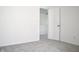 Bedroom featuring neutral gray carpet flooring and a view into another room at 5236 Skipping Stone Dr, Indianapolis, IN 46237