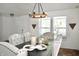 Bright dining room featuring a modern chandelier, stylish decor, and seating for six around the table at 5236 Skipping Stone Dr, Indianapolis, IN 46237