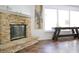 Living room with a stone fireplace, large windows, and a decorative wooden table at 5236 Skipping Stone Dr, Indianapolis, IN 46237