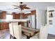 Kitchen and dining area with wood cabinets, stainless steel appliances, and eat-in table with chairs at 5236 Skipping Stone Dr, Indianapolis, IN 46237