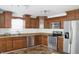 Updated kitchen features stainless steel appliances, wood cabinets, and modern countertops at 5236 Skipping Stone Dr, Indianapolis, IN 46237