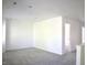 Bright, open living room with neutral gray carpet and access to other rooms at 5236 Skipping Stone Dr, Indianapolis, IN 46237