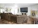Large living room featuring a comfortable sectional sofa, stone fireplace, and TV for relaxing and entertaining guests at 5236 Skipping Stone Dr, Indianapolis, IN 46237