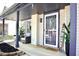Cozy covered front porch with stylish seating, potted plants, and a welcoming entrance to the home at 5236 Skipping Stone Dr, Indianapolis, IN 46237