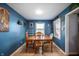 The dining room is a warm setting with blue walls and a wooden table at 5500 W Sudbury Dr, Muncie, IN 47304