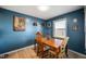 Dining room with traditional wood table, and a view of the outside through a bright window at 5500 W Sudbury Dr, Muncie, IN 47304
