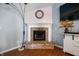 Charming brick fireplace in a cozy corner of the living room, complemented by a decorative clock and stylish lighting at 5500 W Sudbury Dr, Muncie, IN 47304