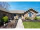 Close-up of the inviting front entrance, showcasing a well-manicured garden and a pathway to the front door at 5500 W Sudbury Dr, Muncie, IN 47304