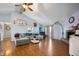 Spacious living room with vaulted ceilings, hardwood floors, a cozy fireplace, and ample natural light at 5500 W Sudbury Dr, Muncie, IN 47304