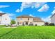 Spacious backyard featuring a fire pit, outdoor furniture, hot tub, and well-maintained lawn at 5595 Auburndale Dr, Bargersville, IN 46106