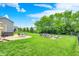 Lush backyard with a hot tub, patio, fire pit area, and mature trees offering plenty of privacy at 5595 Auburndale Dr, Bargersville, IN 46106