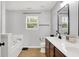 Bright bathroom featuring a soaking tub, double sink vanity with dark cabinetry and modern fixtures at 5595 Auburndale Dr, Bargersville, IN 46106