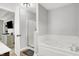 Bright bathroom showcasing a soaking tub, a separate shower stall, and dark cabinets in the vanity at 5595 Auburndale Dr, Bargersville, IN 46106