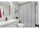 Stylish bathroom features a modern vanity, decorative mirror, and a shower with patterned curtain at 5595 Auburndale Dr, Bargersville, IN 46106