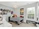 Cozy bedroom with a chandelier, sports decor, and a bright window; perfect for a young athlete at 5595 Auburndale Dr, Bargersville, IN 46106