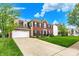 Charming home with a spacious driveway, manicured lawn, and an inviting facade at 5595 Auburndale Dr, Bargersville, IN 46106