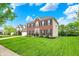 Beautiful two-story home featuring a well-manicured lawn and mature trees at 5595 Auburndale Dr, Bargersville, IN 46106