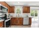 Bright kitchen featuring stainless steel appliances, granite countertops, subway tile backsplash, and a view to the backyard at 5595 Auburndale Dr, Bargersville, IN 46106