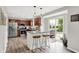 Modern kitchen with stainless steel appliances, island with stools and bar style lighting and granite countertops at 5595 Auburndale Dr, Bargersville, IN 46106