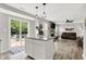 Kitchen area with stainless steel appliances, a white island, and sliding doors to the back yard at 5595 Auburndale Dr, Bargersville, IN 46106