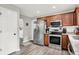 A kitchen featuring wood cabinets, stainless steel appliances, granite countertops, and modern lighting at 5595 Auburndale Dr, Bargersville, IN 46106