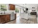 Kitchen with granite countertops, an island, wood cabinets, view to the living room and access to the back yard at 5595 Auburndale Dr, Bargersville, IN 46106