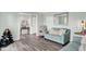 Cozy living room with stylish decor, light blue walls and durable wood-look flooring at 5595 Auburndale Dr, Bargersville, IN 46106